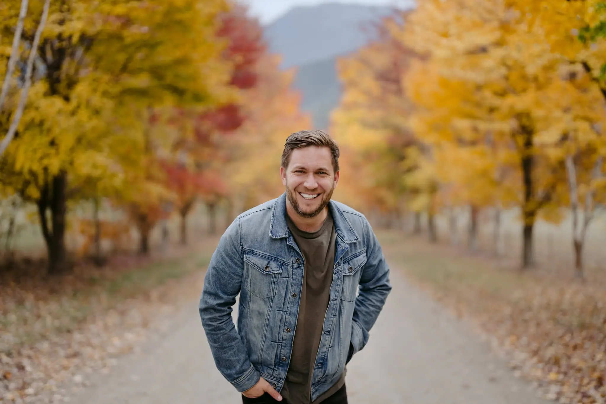 Michael Briggs photographing in an autumn avenue