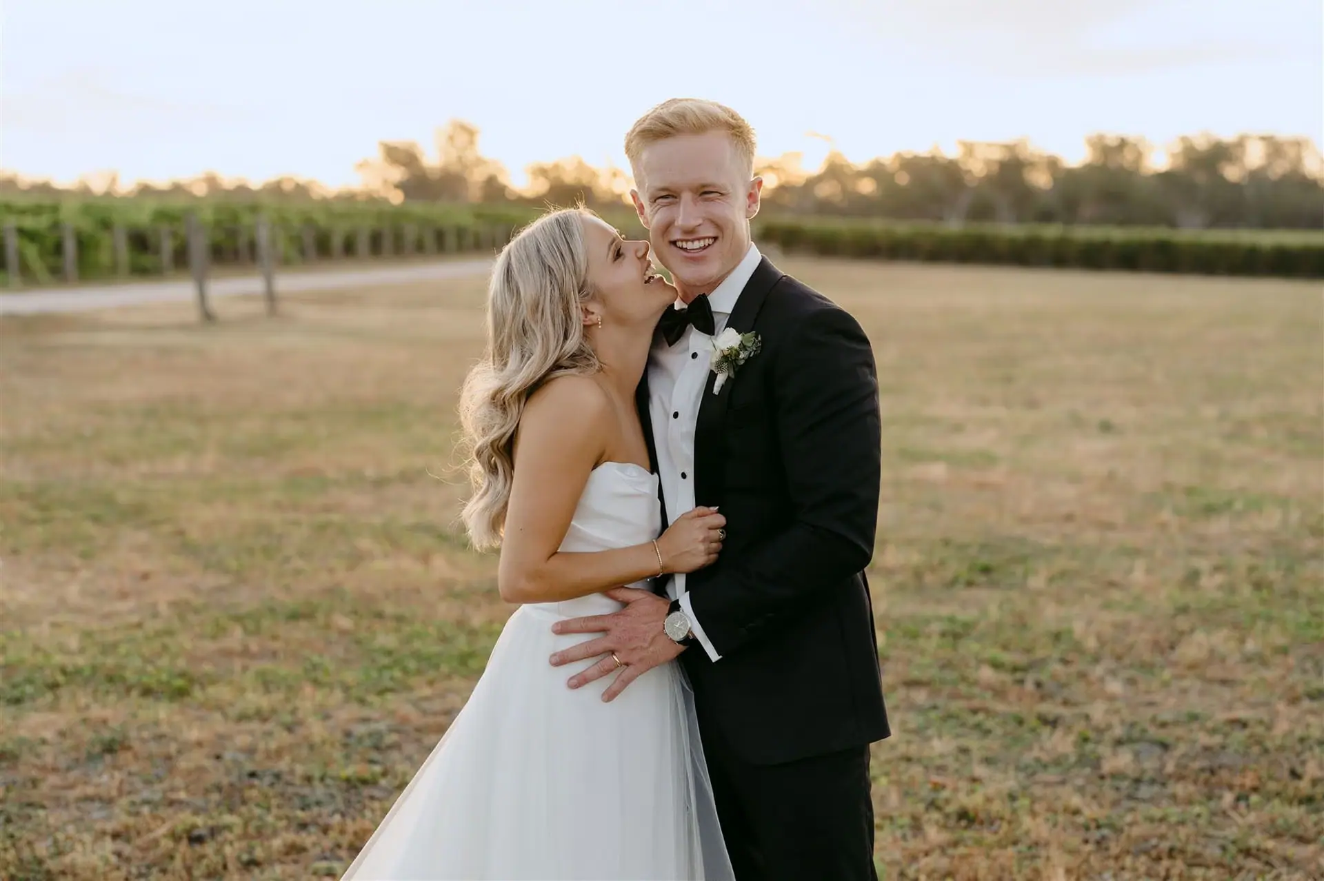 Jess and Nathan holding each other in a Yarra Valley paddock