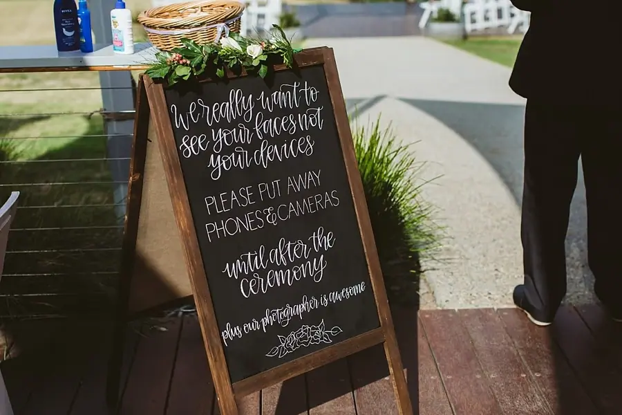 Chalkboard asking guests to put away phones and cameras during the ceremony.