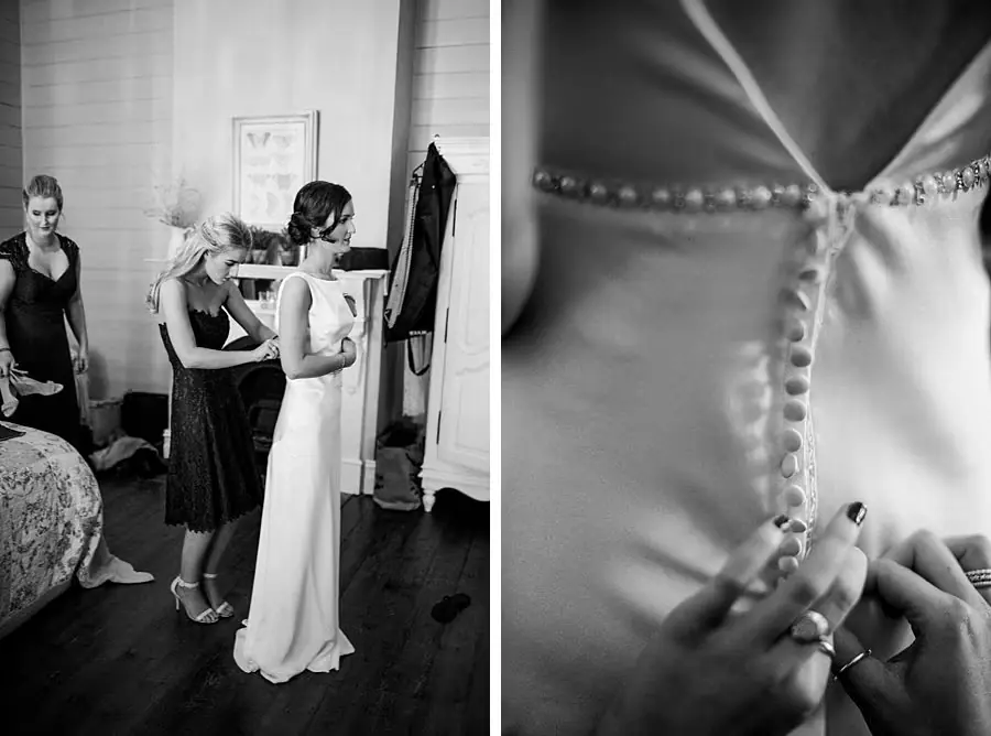 Two black and white photographs of friends helping the bride and fastening dress buttons.