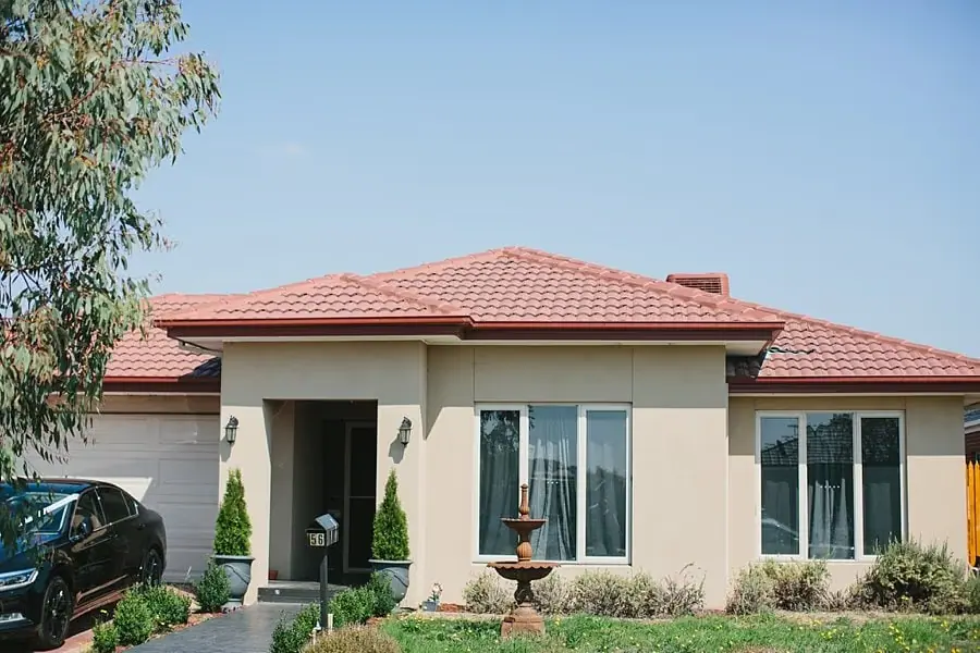 Single-storey house with a tiled red roof and a small front garden.