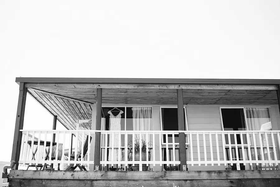 Black-and-white view of a weatherboard house veranda.