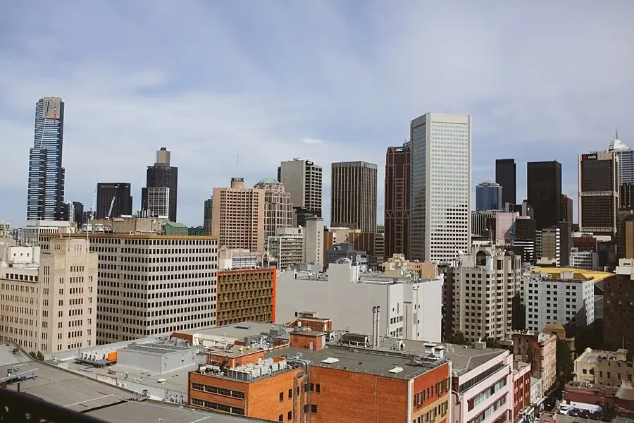 City skyline above a dense cluster of lower buildings.