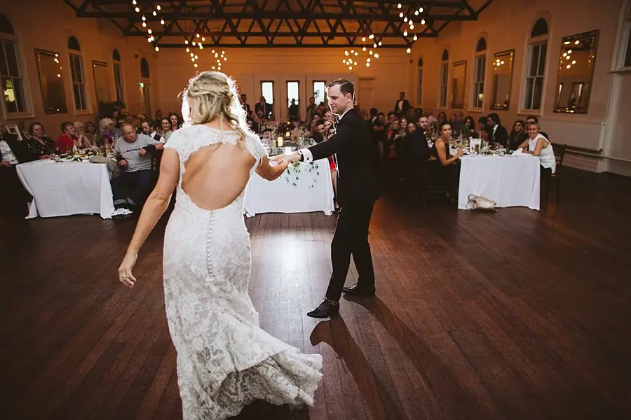 Bride and groom dancing together in the reception hall.