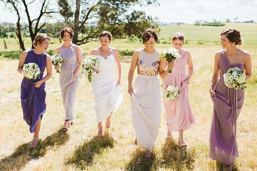 Bride and bridesmaids walking with their bouquets