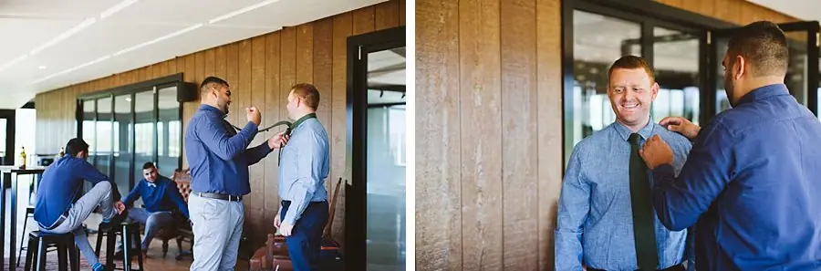 Groomsmen helping each other put on ties