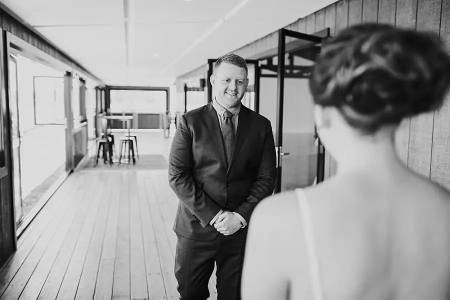 Groom smiling at the bride during their first look