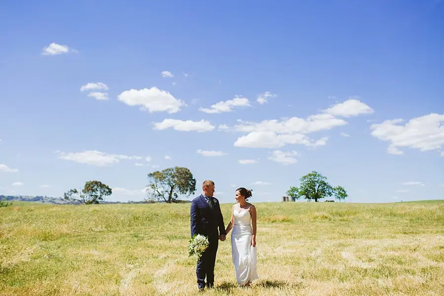 Couple standing together in an open paddock
