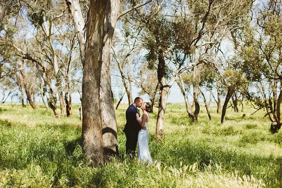 Couple embracing among the trees