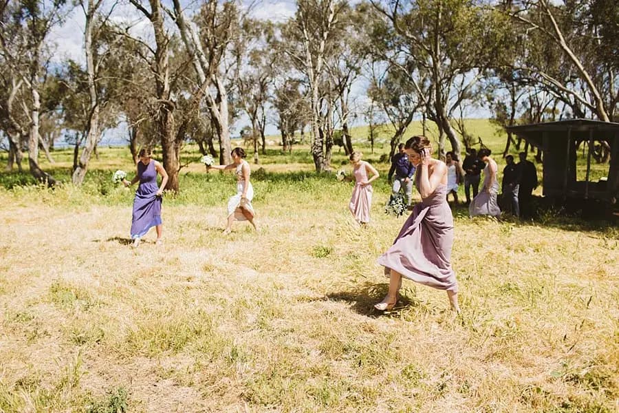 Bridesmaids walking across the paddock