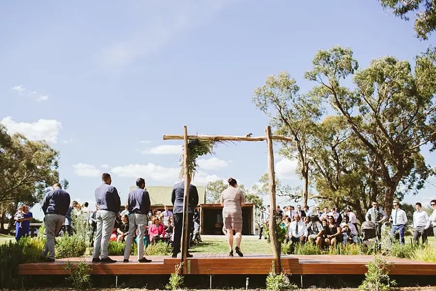 Guests gathered around the outdoor ceremony arbour