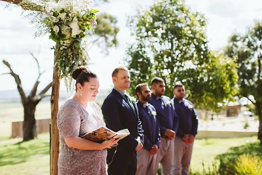 Groom and groomsmen waiting with the celebrant