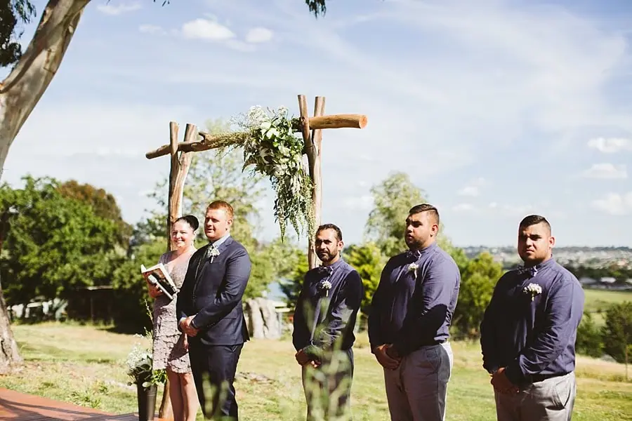 Groom and groomsmen watching the bride arrive