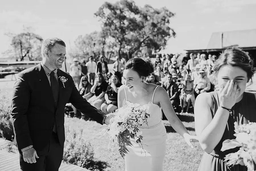 Black-and-white photograph of the bride arriving at the ceremony