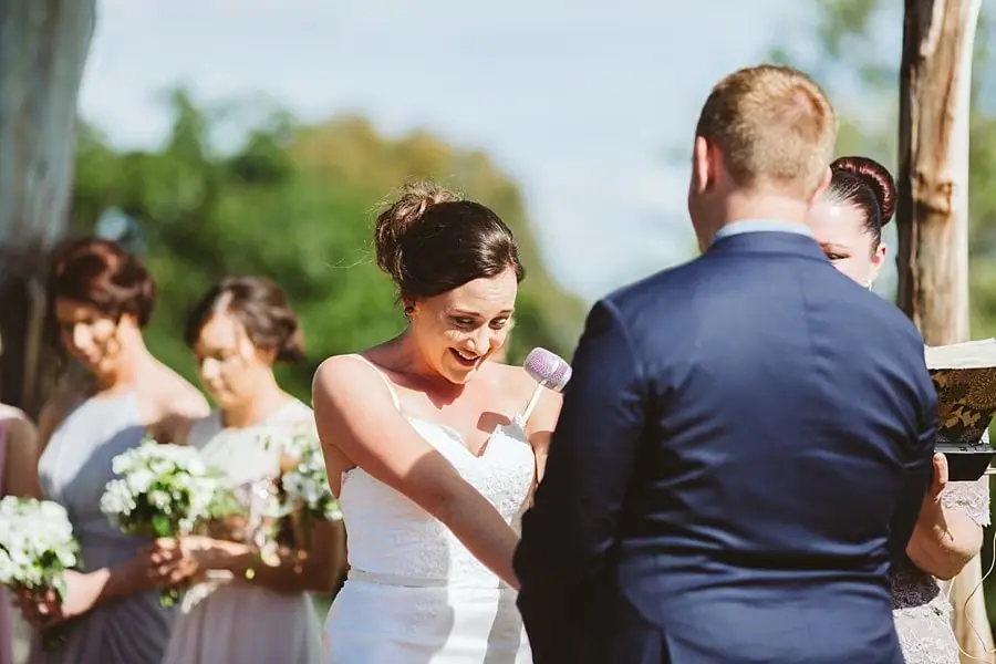 Bride smiling while reading her vows