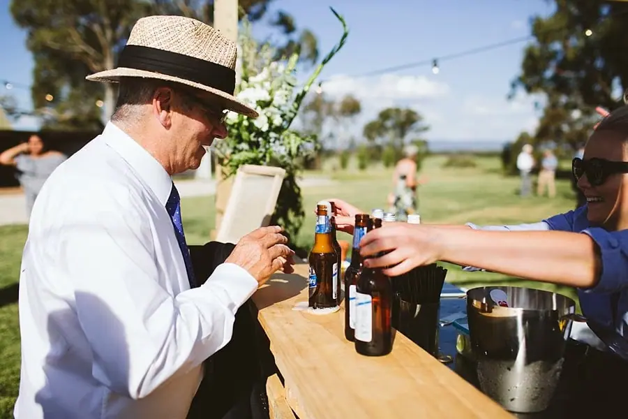 Guest pouring a drink at the outdoor bar