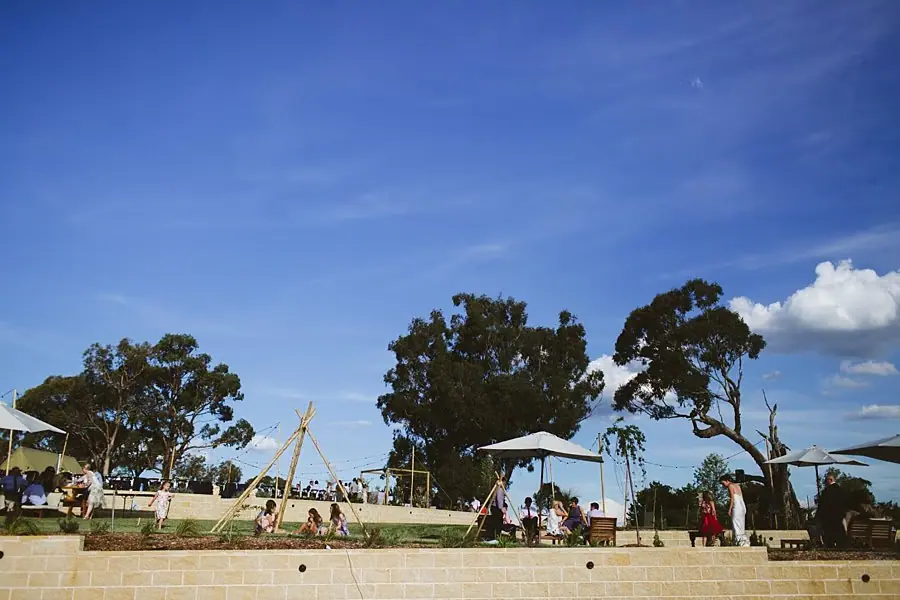 Guests relaxing on the Boxgrove lawn under a blue sky