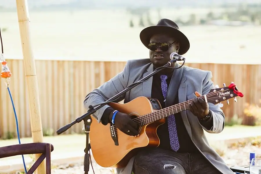 Musician singing and playing acoustic guitar