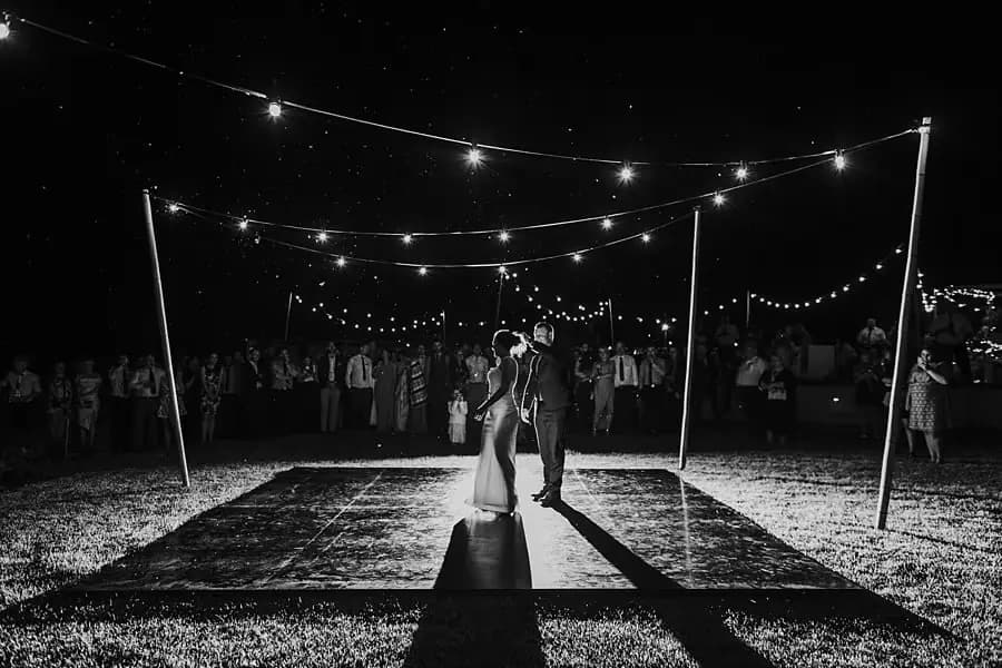 Black-and-white wide view of the couple's first dance