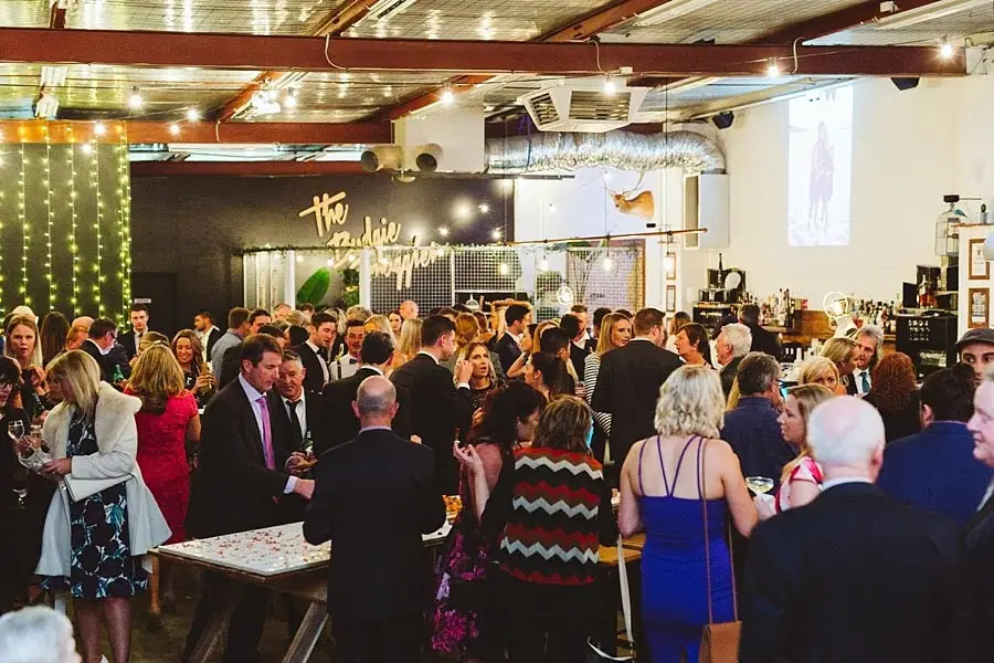 Guests mingling in a warmly lit reception room.