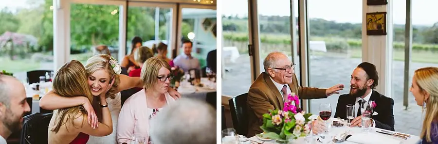 Two photographs of guests hugging and talking around flower-decorated reception tables.