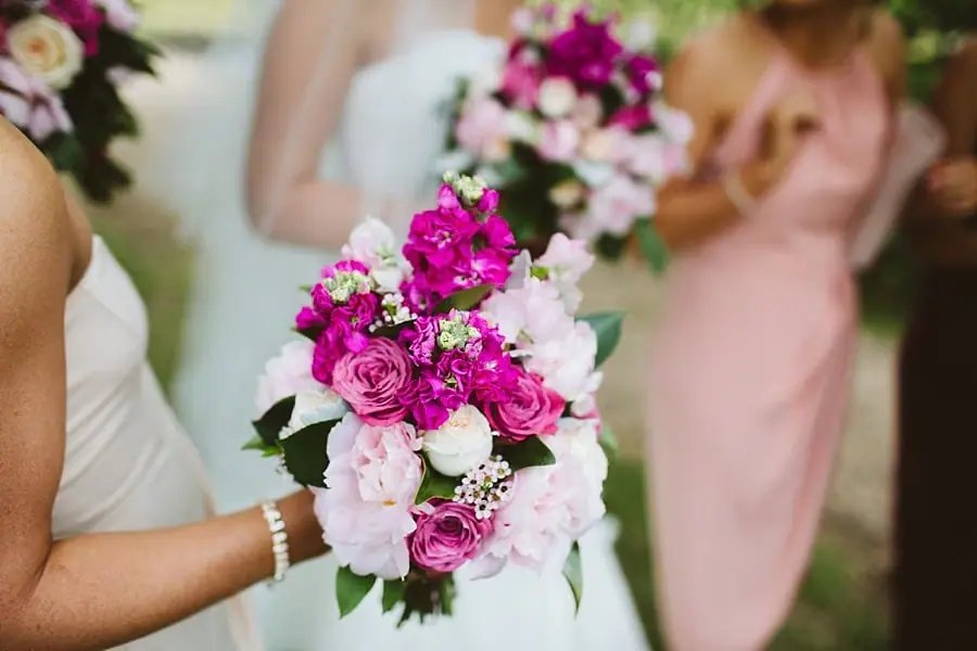 Pink and white bouquets held by the bride and a bridesmaid.