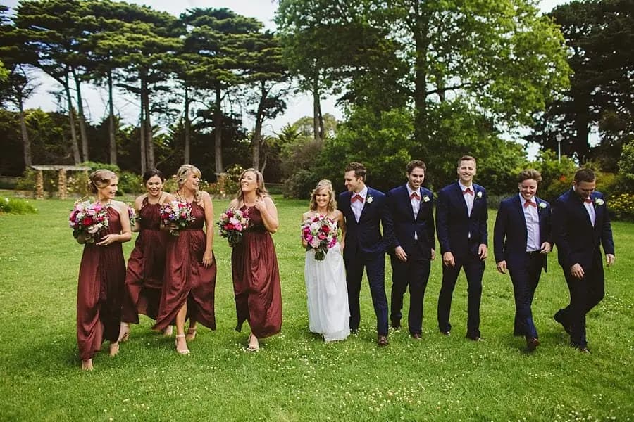 Wedding party walking together across the grounds.
