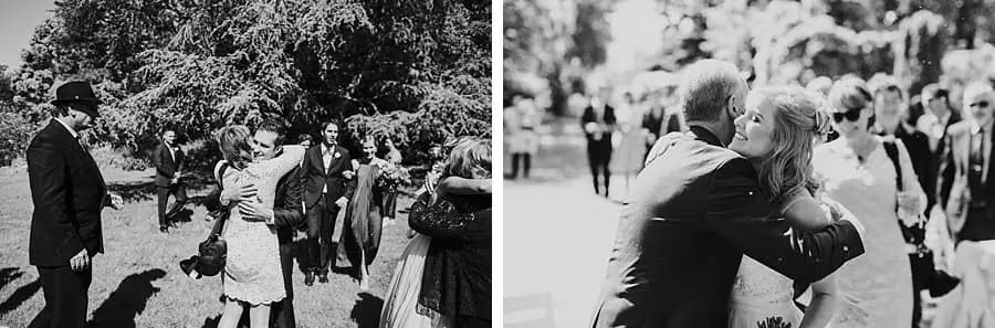 Two black-and-white photographs of guests greeting and embracing the couple.
