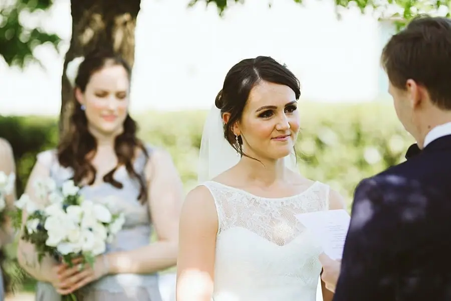 Bride looking at the groom during the outdoor ceremony.