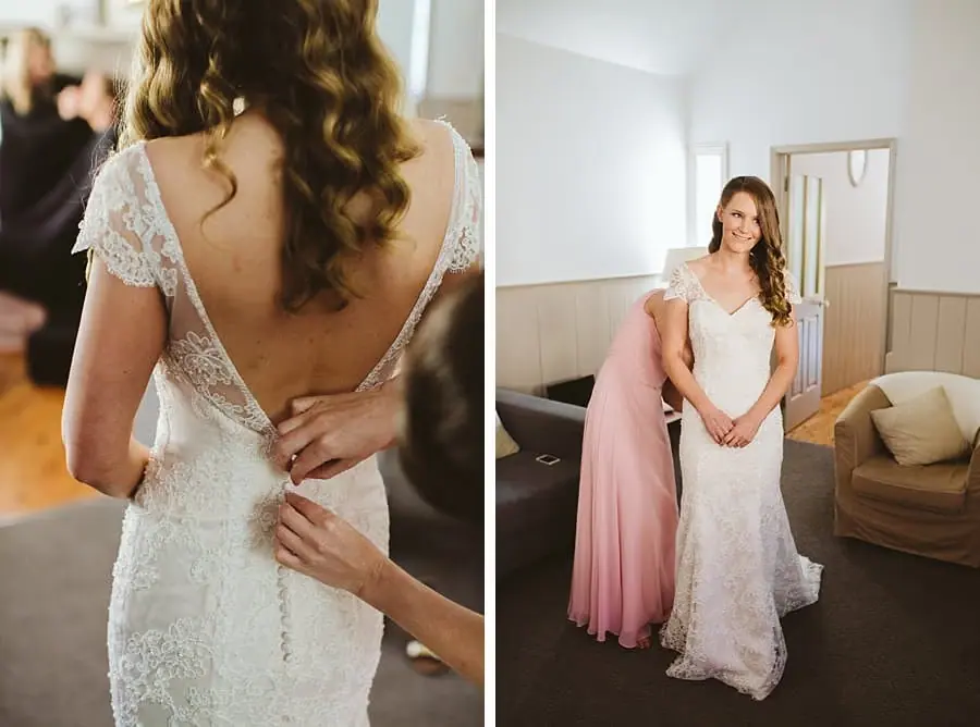 Two photographs of the bride's lace dress being fastened and a friend standing beside her