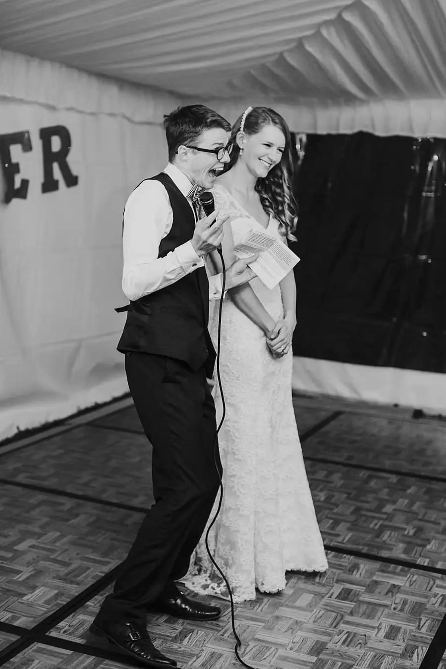 Black-and-white photograph of the bride and groom dancing together