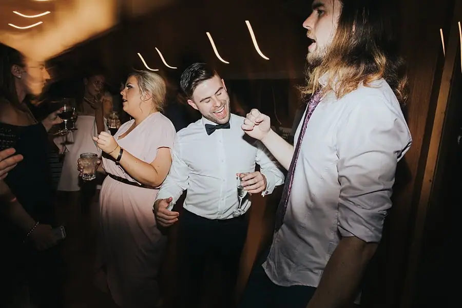 Guests laughing and dancing together at the evening reception.