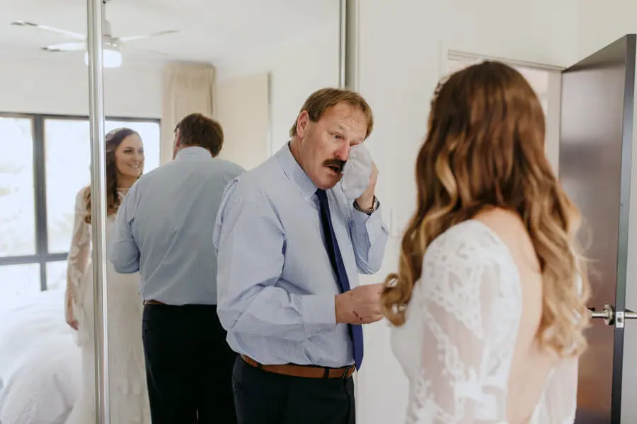 Man touching his eye as he sees the bride during preparations.