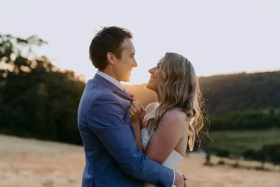 Bride and groom looking at each other in warm evening sunlight