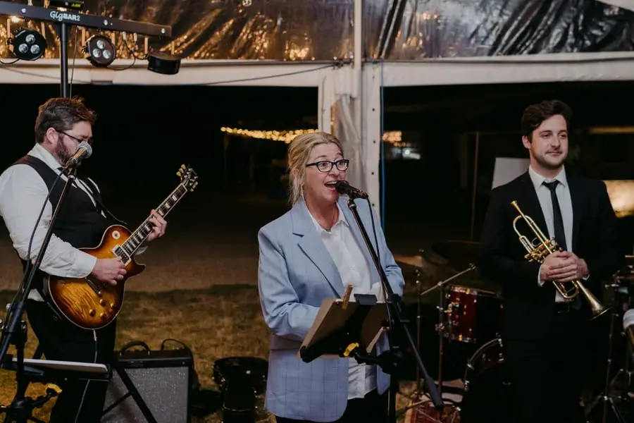 Singer and musicians performing beside the evening dance floor