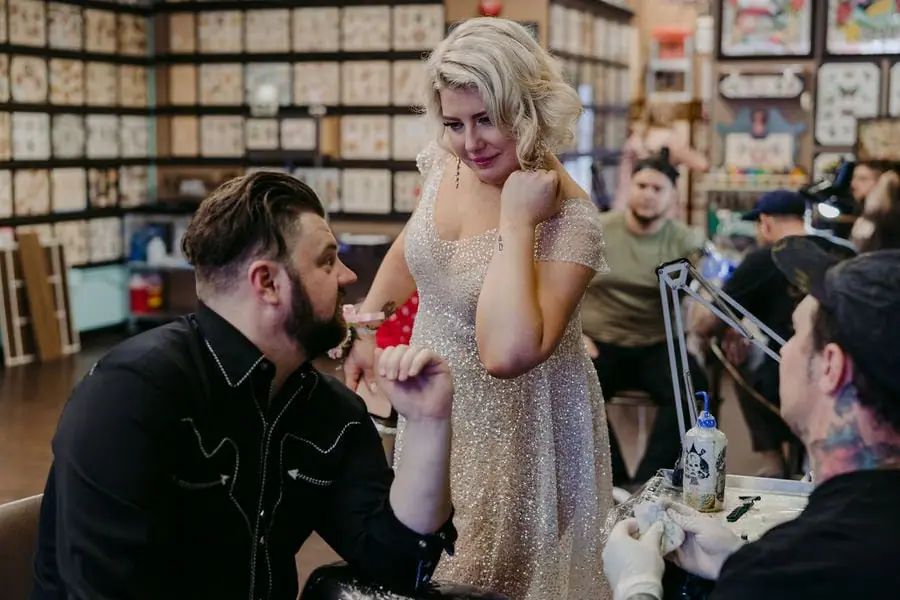 Couple smiles toward each other inside a shop filled with records.