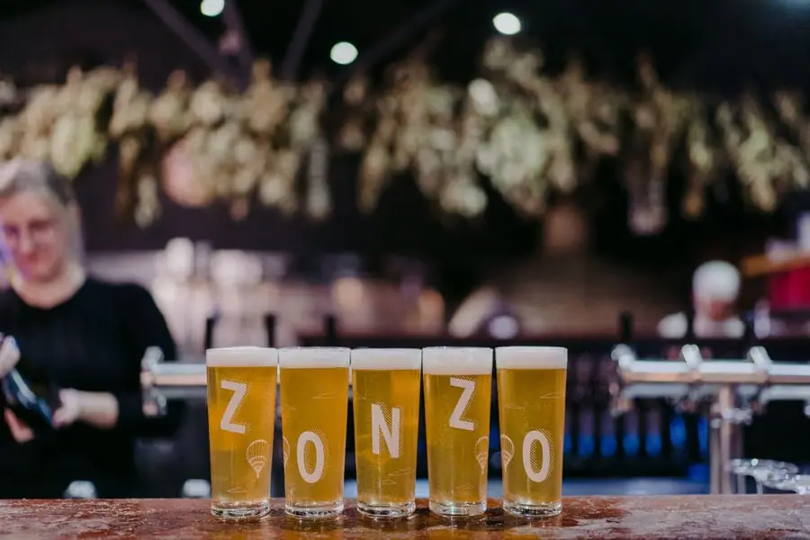 Five filled beer glasses stand in a row on the reception bar.