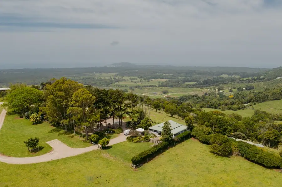 Aerial view of a wedding venue and lawns surrounded by green rolling countryside