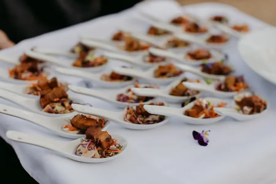 Tray of small appetisers served in white ceramic spoons
