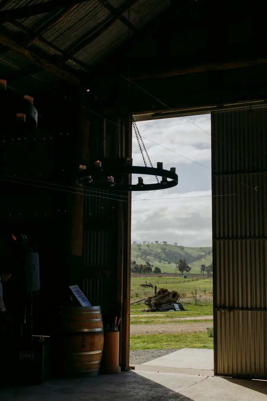 Open barn doorway framing green hills in the distance