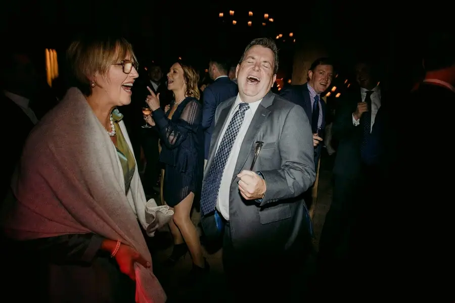 Guests laughing and singing together on the dance floor