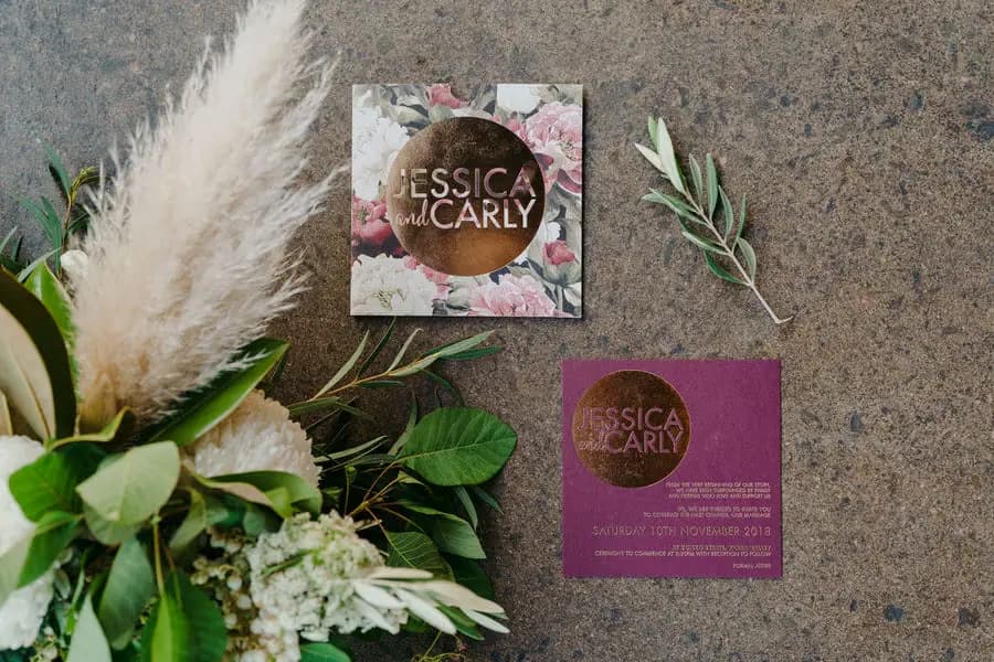 Wedding stationery and a bouquet arranged on the ground