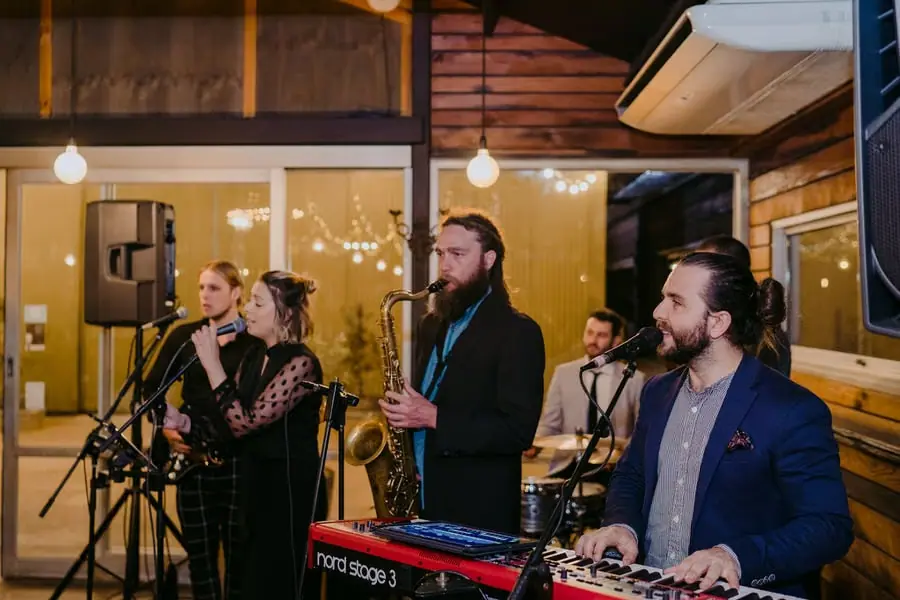 Live band performing with vocalists, saxophone, keyboard and drums