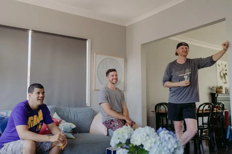 Men laughing together in casual clothes before getting ready