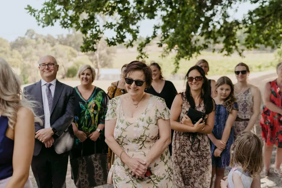 Standing guests watching the bride approach the ceremony