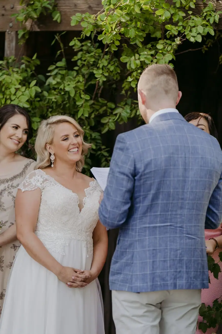 Bride smiling at the groom during their outdoor ceremony