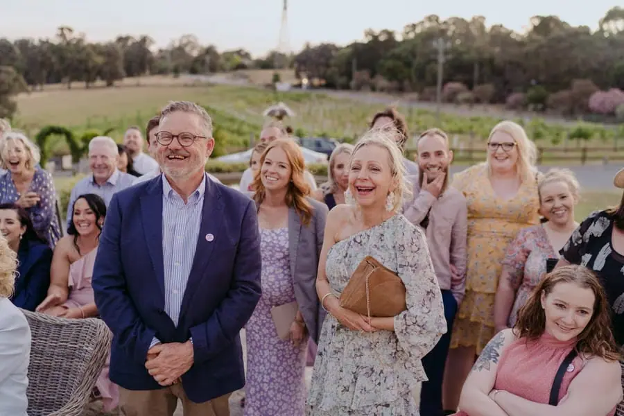 Guests smiling together with the countryside behind them