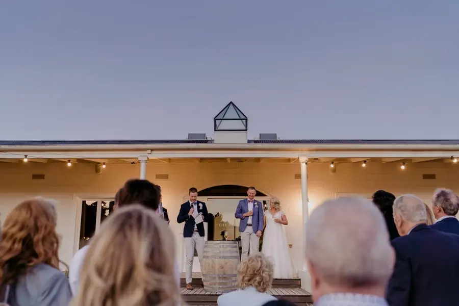 View from behind guests toward speeches on the reception verandah