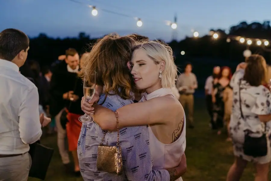 Two guests hugging on the outdoor dance floor