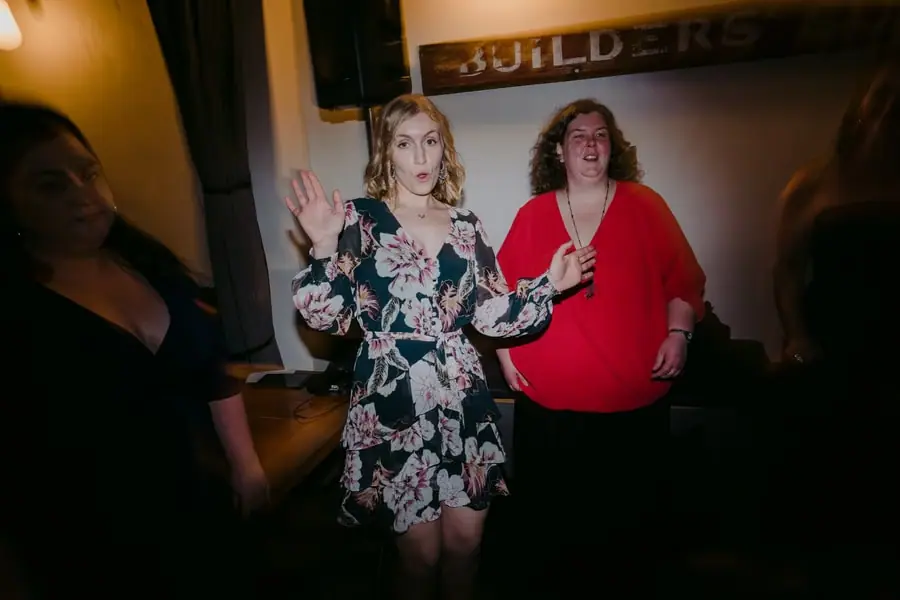 Guests dancing together with their arms raised